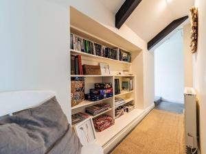a bedroom with a book shelf with books at Holiday Home Cobble Cottage by Interhome in Lerryn