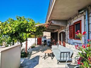 a patio of a house with chairs and a table at Holiday Home Prusina by Interhome in Smokvica
