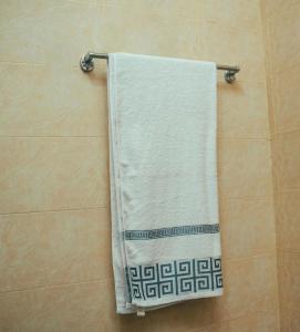 a towel hanging on a towel rack in a bathroom at NJIRO 4BDR FAMILY HOME NEAR RESTURANTs AFCON EXERCISE Field in Arusha +20 photos