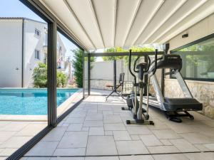 a gym with a view of a swimming pool at Apartment Dita-5 by Interhome in Crikvenica