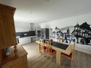 a kitchen with a table and chairs in a room at COLMAR and C0 in Ingersheim