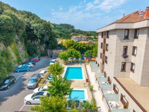 arial view of a parking lot with a swimming pool at Apartamentos Los Arces in Isla