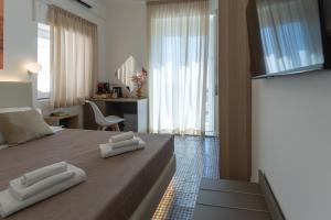 a bedroom with a bed with two towels on it at Light View in Taormina
