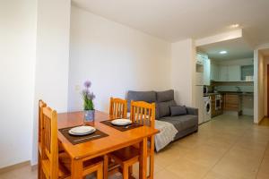 a living room with a table and a couch at Villamagna Pueblo Vidaber in Oropesa del Mar