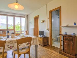 a dining room with a table and a bathroom at Apartment Bravone by Interhome in Abetone