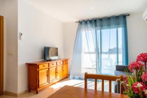 a living room with a tv and a window at Villamagna Pueblo Vidaber in Oropesa del Mar