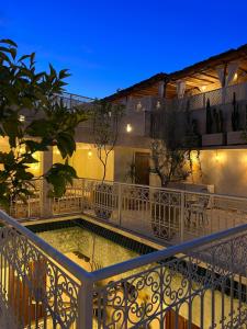 ein Pool auf dem Balkon eines Gebäudes bei Nacht in der Unterkunft Riad Noon in Marrakesch + 40 Fotos