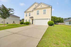 a house with a driveway in a yard at Spacious Home with Screened Patio in Pooler! in Pooler
