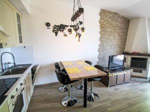 a kitchen with a table with chairs and a laptop at Apartment Villa Castiglioni by Interhome in Luino