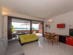a living room with a yellow couch and a table at Apartment Norby by Interhome in Ghiffa