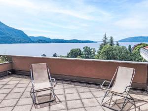 two chairs on a balcony with a view of a lake at Apartment Norby by Interhome in Ghiffa