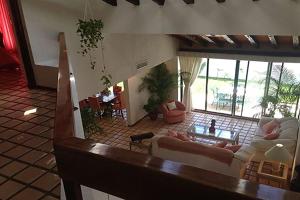 a living room with a couch and a table at Cancún Villa Marina Blanca in Cedro +28 photos