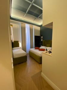 Postel nebo postele na pokoji v ubytování Unicum Trastevere Suites
