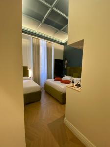Postel nebo postele na pokoji v ubytování Unicum Trastevere Suites