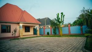 a house with a red roof and a brick driveway at NJIRO 4BDR FAMILY HOME NEAR RESTURANTs AFCON EXERCISE Field in Arusha
