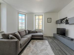 a living room with a couch and a tv at Apartment Leoni by Interhome in Rovereto +18 photos
