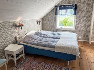 a bedroom with a bed and a window at Holiday Home Skyberga Torp by Interhome in Kumla