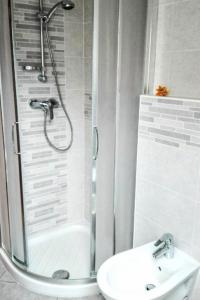 a bathroom with a shower and a toilet and a sink at Apartment Boschetto by Interhome in Riva del Garda