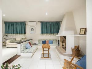 a living room with couches and a fireplace at Villa Villa Al Mare by Interhome in Su Forti