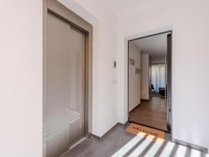 a hallway with a large glass door and a hallway leading into a room at Apartment Maria by Interhome in Pinzolo