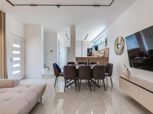 a dining room and living room with a table and chairs at Villa Ivica & Marica by Interhome in Maslenica +72 photos
