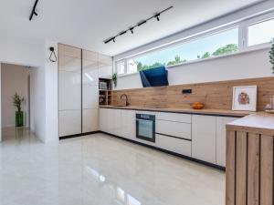 a kitchen with white cabinets and a large window at Villa Ivica & Marica by Interhome in Maslenica