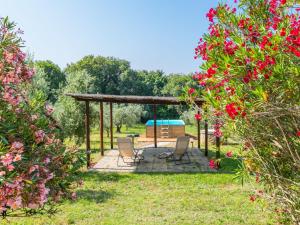 a gazebo with chairs sitting on a patio at Holiday Home Rustico by Interhome in Bibbona
