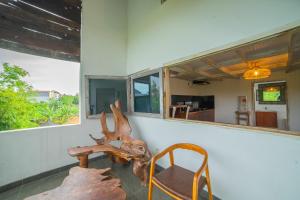 a room with a table and a chair and a mirror at The Sri Loft in Dalung