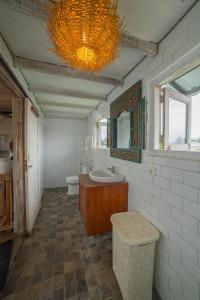 a bathroom with a sink and a toilet and a mirror at The Sri Loft in Dalung +18 photos