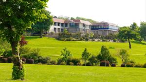 a large house on a lush green field at Westlodge Hotel & Leisure Centre in Bantry