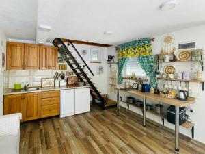 a kitchen with wooden cabinets and a wooden floor at Property with your own beach and pool - Whispering Waters in Krupa na Vrbasu