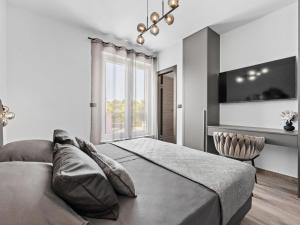 a bedroom with a large bed and a window at Villa Delecto by Interhome in Pula