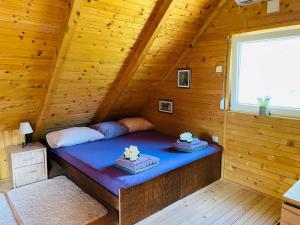 a room with a bed in a wooden cabin at Property with your own beach and pool - Whispering Waters in Krupa na Vrbasu +45 photos