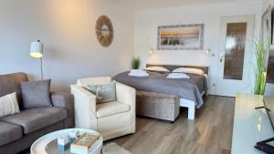 a living room with a bed and a couch at Strand-Gut, 12-29 in Westerland (Sylt)