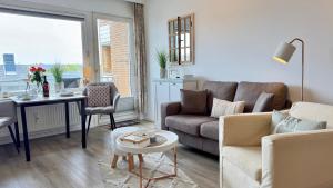 a living room with a couch and a table at Strand-Gut, 12-29 in Westerland (Sylt)