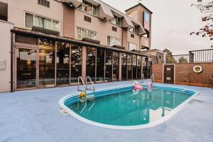 a swimming pool in front of a building at SureStay Plus by Best Western Coquitlam in Coquitlam