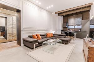 a living room with a couch and a table at Casa Sapienza - Luxury Apartment in the Centre in Siena