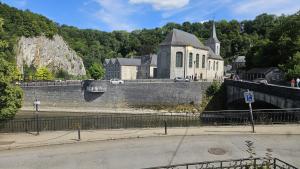 a large building on a bridge with a church at La Maison de Durbuy in Durbuy +11 photos