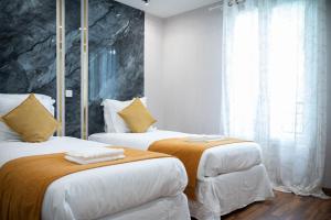 Katil atau katil-katil dalam bilik di Bussy Luxury Villa Disneyland Paris