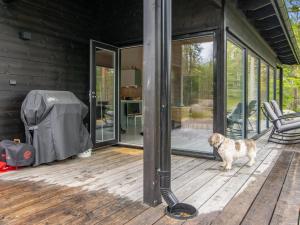 a dog standing on the deck of a house at Holiday Home Sarppala by Interhome in Putkijärvi