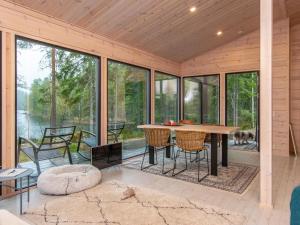 a screened in porch with a table and chairs at Holiday Home Sarppala by Interhome in Putkijärvi +19 photos