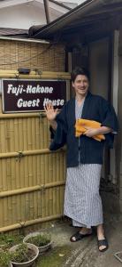 a man standing in front of a guest house at Fuji-Hakone Guest House in Hakone