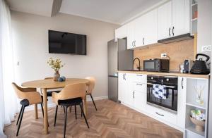 a kitchen with a table and chairs in a room at River View Ruse, Free,underground Parking in Ruse