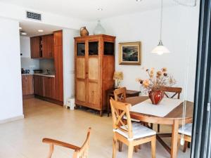 a kitchen and dining room with a table and chairs at Apartment La Platja by Interhome in L'Estartit
