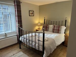 Katil atau katil-katil dalam bilik di Bracken Cottage