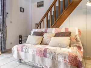 a couch in a living room with a staircase at Holiday Home Hacienda Beach II-7 by Interhome in Agde