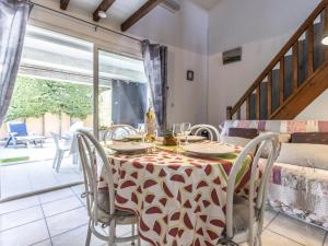 a dining room with a table and chairs at Holiday Home Hacienda Beach II-7 by Interhome in Agde +23 photos