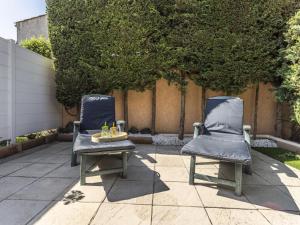 two chairs sitting on a patio with a table at Holiday Home Hacienda Beach II-7 by Interhome in Agde