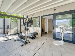 a gym with a treadmill and ellipticals in a building at Apartment Dita-1 by Interhome in Crikvenica