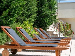 a row of lounge chairs sitting on a patio at Apartment Dita-1 by Interhome in Crikvenica